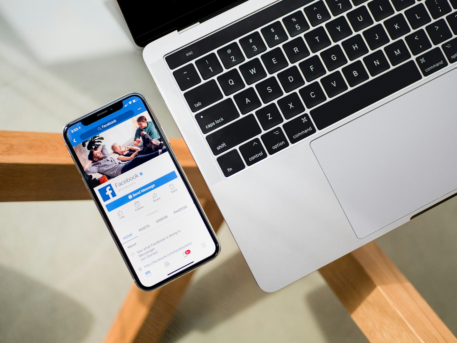 iPhone X beside MacBook, Facebook icon, what to do if Facebook account is hacked